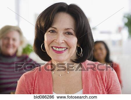 Stock Photograph - Smiling woman with friends. Fotosearch
