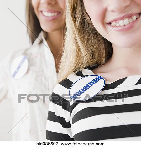 Teenage girls wearing volunteer badges View Large Photo Image Stock Image - Teenage girls wearing volunteer badges. Fotosearch
