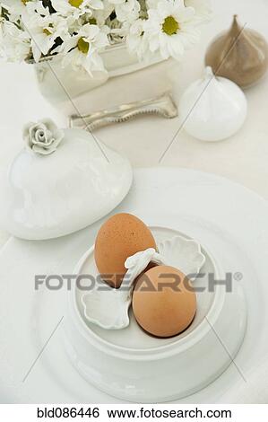 Stock Photograph - Two boiled eggs in an ornate egg cup. Fotosearch