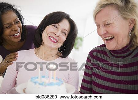 Women surprising friend with birthday cake View Large Photo Image Stock Image - Women surprising friend with birthday cake. Fotosearch