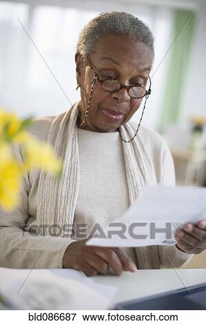 Stock Photo - Black woman reading letter. Fotosearch