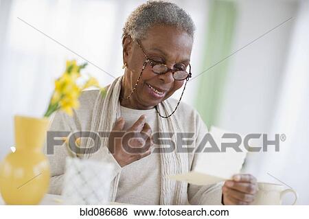 Black woman reading letter View Large Photo Image Stock Photograph - Black woman reading letter. Fotosearch