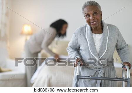 Black woman walking with walker in bedroom View Large Photo Image Stock Photo - Black woman walking with walker in bedroom. Fotosearch