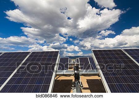 Stock Photograph - Blue sky over solar panels. Fotosearch