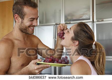 Caucasian man feeding wife grapes View Large Photo Image Stock Photo - Caucasian man feeding wife grapes. Fotosearch