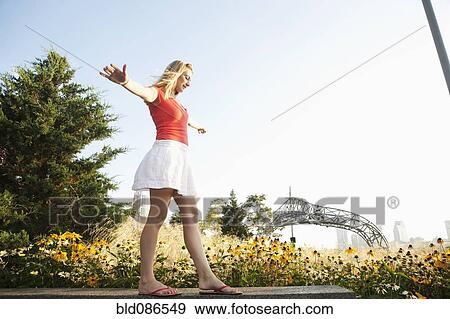 Caucasian teenager balancing on bench View Large Photo Image Stock Photo - Caucasian teenager balancing on bench. Fotosearch