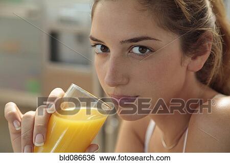 Caucasian woman drinking orange juice View Large Photo Image Stock Photograph - Caucasian woman drinking orange juice. Fotosearch