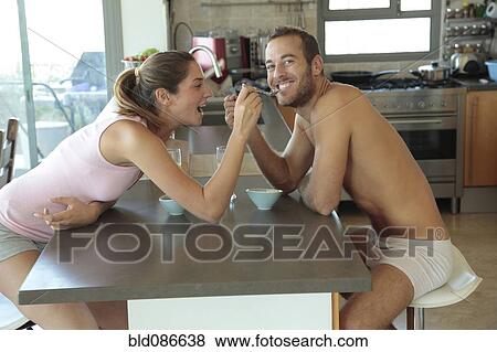 Stock Photo - Caucasian woman feeding breakfast to husband. Fotosearch