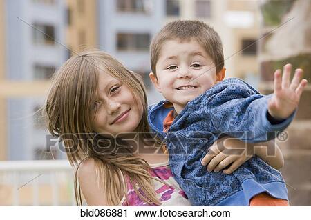 Stock Image - Chilean brother and sister hugging. Fotosearch