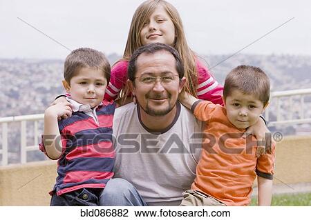 Stock Image - Chilean family posing outdoors. Fotosearch