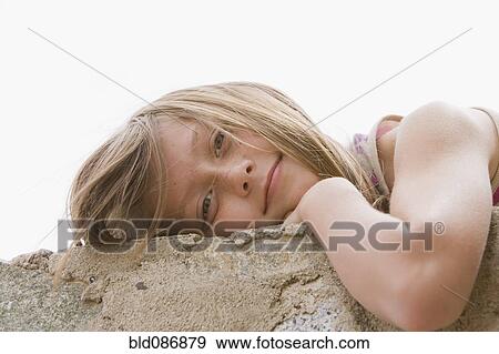 Chilean girl laying on wall View Large Photo Image Stock Photo - Chilean girl laying on wall. Fotosearch