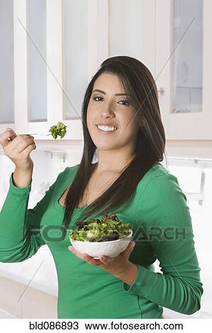 Hispanic woman eating salad View Large Photo Image Stock Image - Hispanic woman eating salad. Fotosearch