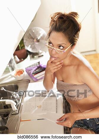 Stock Photograph - Hispanic woman studying at home. Fotosearch