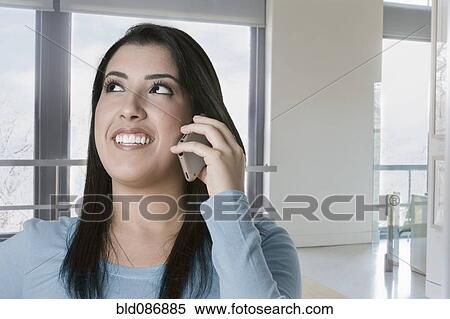 Hispanic woman talking on cell phone View Large Photo Image Stock Photography - Hispanic woman talking on cell phone. Fotosearch