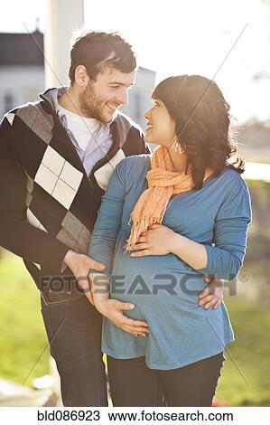 Husband hugging pregnant wife View Large Photo Image Stock Image - Husband hugging pregnant wife. Fotosearch