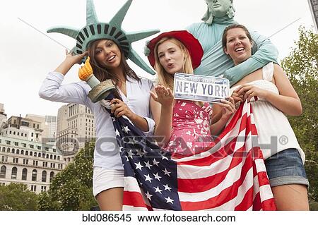 Laughing friends visiting the Statue of Liberty View Large Photo Image Stock Photography - Laughing friends visiting the Statue of Liberty. Fotosearch