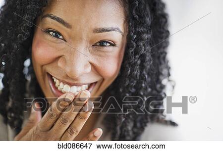 Stock Photo - Laughing mixed race woman. Fotosearch