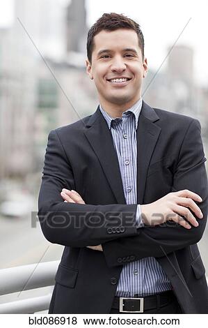 Stock Photo - Mixed race businessman standing outdoors. Fotosearch