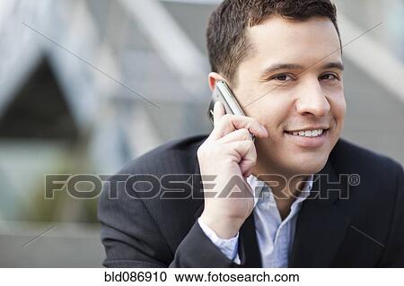 Mixed race businessman talking on cell phone View Large Photo Image Stock Image - Mixed race businessman talking on cell phone. Fotosearch