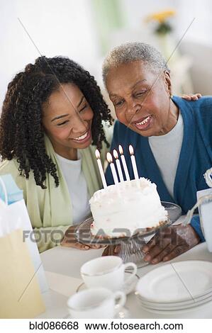 Stock Photo - Mother and daughter celebrating birthday. Fotosearch