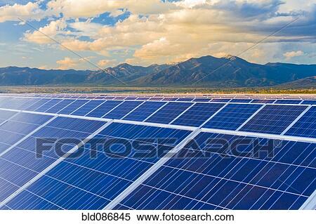 Stock Photography - Mountains behind solar panels. Fotosearch