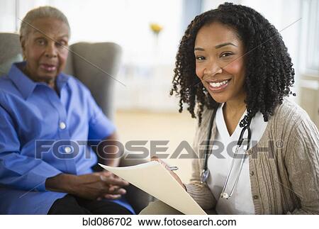 Nurse giving woman checkup View Large Photo Image Stock Image - Nurse giving woman checkup. Fotosearch