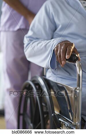 Nurse pushing woman in wheelchair View Large Photo Image Stock Photograph - Nurse pushing woman in wheelchair. Fotosearch