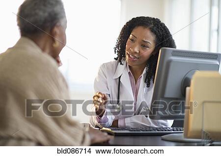 Picture - Nurse talking to patient. Fotosearch
