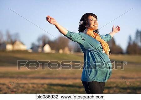 Pregnant mixed race woman in field with arms outstretched View Large Photo Image Stock Image - Pregnant mixed race woman in field with arms outstretched. Fotosearch