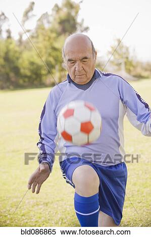 Stock Photography - Senior Chilean soccer player bouncing soccer ball. Fotosearch