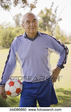 Stock Image - Senior Chilean soccer player holding soccer ball. Fotosearch