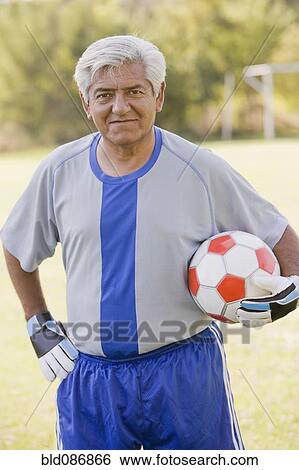 Stock Photograph - Senior Chilean soccer player holding soccer ball. Fotosearch