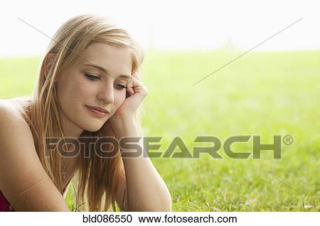 Serious Caucasian teenage girl sitting in grass View Large Photo Image Stock Image - Serious Caucasian teenage girl sitting in grass. Fotosearch