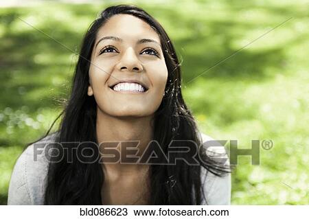 Smiling Hispanic teenager sitting in grass View Large Photo Image Stock Image - Smiling Hispanic teenager sitting in grass. Fotosearch