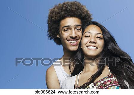 Picture - Smiling teenage couple outdoors. Fotosearch