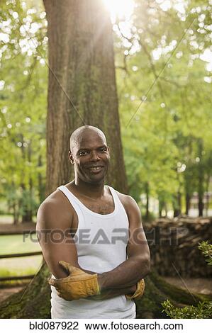 Stock Image - African American man in gloves standing outdoors. Fotosearch