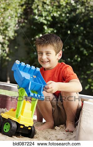 Caucasian boy playing in sandbox View Large Photo Image Picture - Caucasian boy playing in sandbox. Fotosearch
