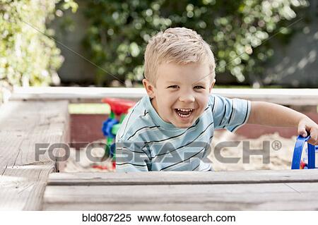 Caucasian boy playing in sandbox View Large Photo Image Stock Photography - Caucasian boy playing in sandbox. Fotosearch