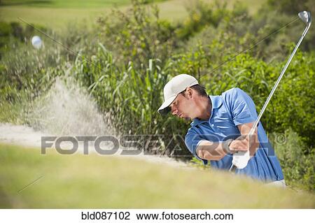 Caucasian golfer hitting ball out of bunker View Large Photo Image Stock Image - Caucasian golfer hitting ball out of bunker. Fotosearch