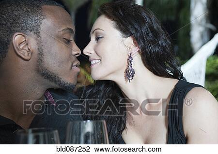 Stock Image - Couple kissing at night. Fotosearch