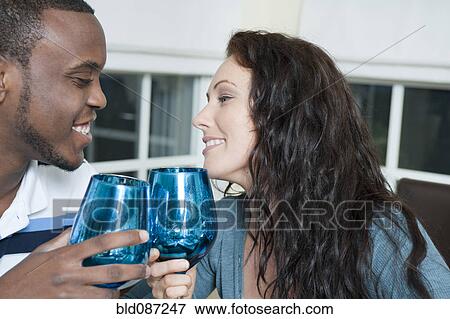 Stock Photo - Couple toasting with wine glasses. Fotosearch