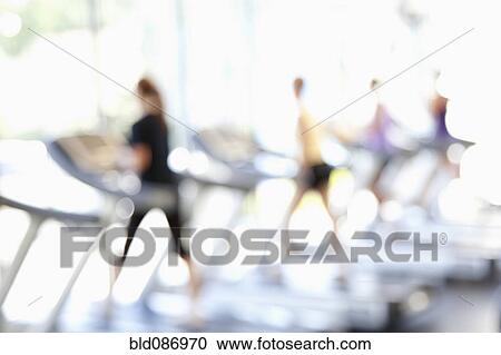 Defocused view of people on treadmills in health club View Large Photo Image Stock Image - Defocused view of people on treadmills in health club. Fotosearch