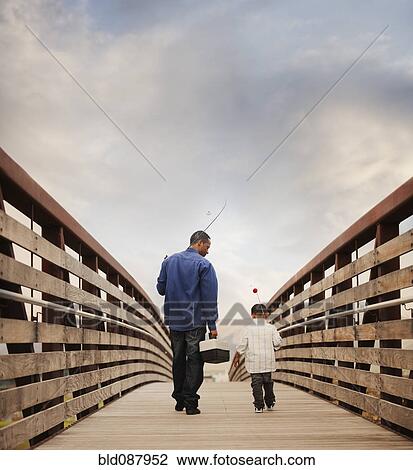 Stock Image - Father and son going fishing together. Fotosearch