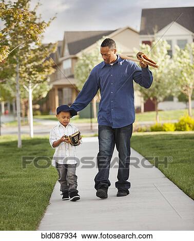Father and son walking with baseball glove and bat View Large Photo Image Picture - Father and son walking with baseball glove and bat. Fotosearch