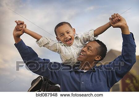 Father carrying son on back View Large Photo Image Stock Photo - Father carrying son on back. Fotosearch