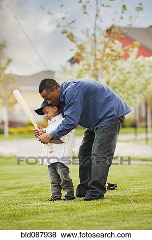 Father teaching son to play baseball View Large Photo Image Stock Photo - Father teaching son to play baseball. Fotosearch