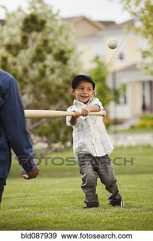 Stock Photo - Father teaching son to play baseball. Fotosearch
