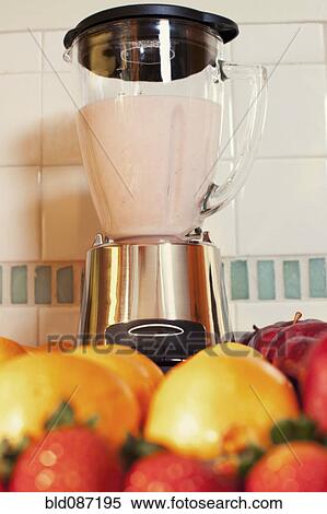 Stock Photography - Fruits and blender in kitchen counter. Fotosearch