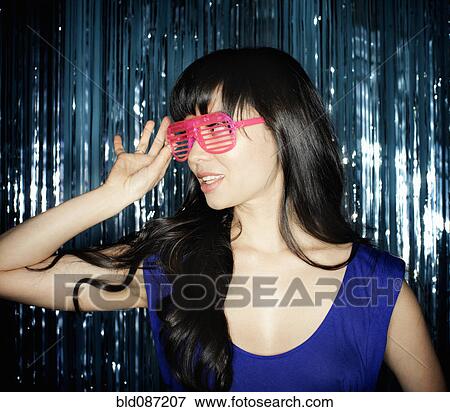 Stock Photo - Glamorous mixed race woman in unusual sunglasses. Fotosearch