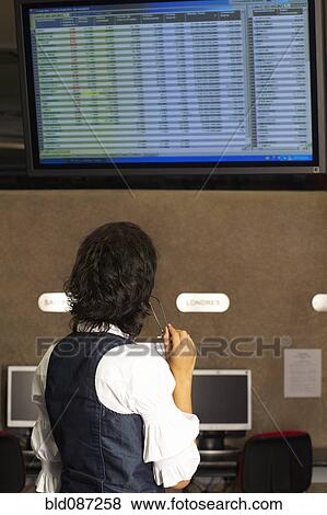 Hispanic businesswoman looking at wall monitor View Large Photo Image Stock Photo - Hispanic businesswoman looking at wall monitor. Fotosearch